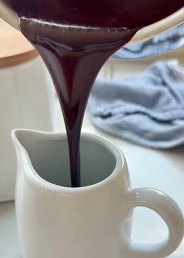 Dark red velvet lava pouring into a white jug