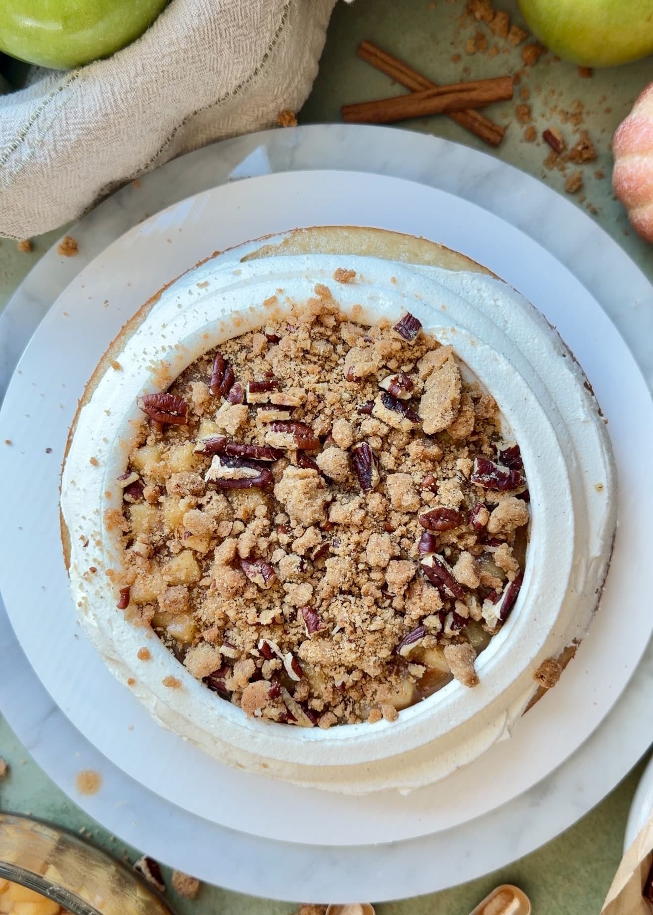 Brown sugar pecan streusel layered over apples inside a buttercream dam