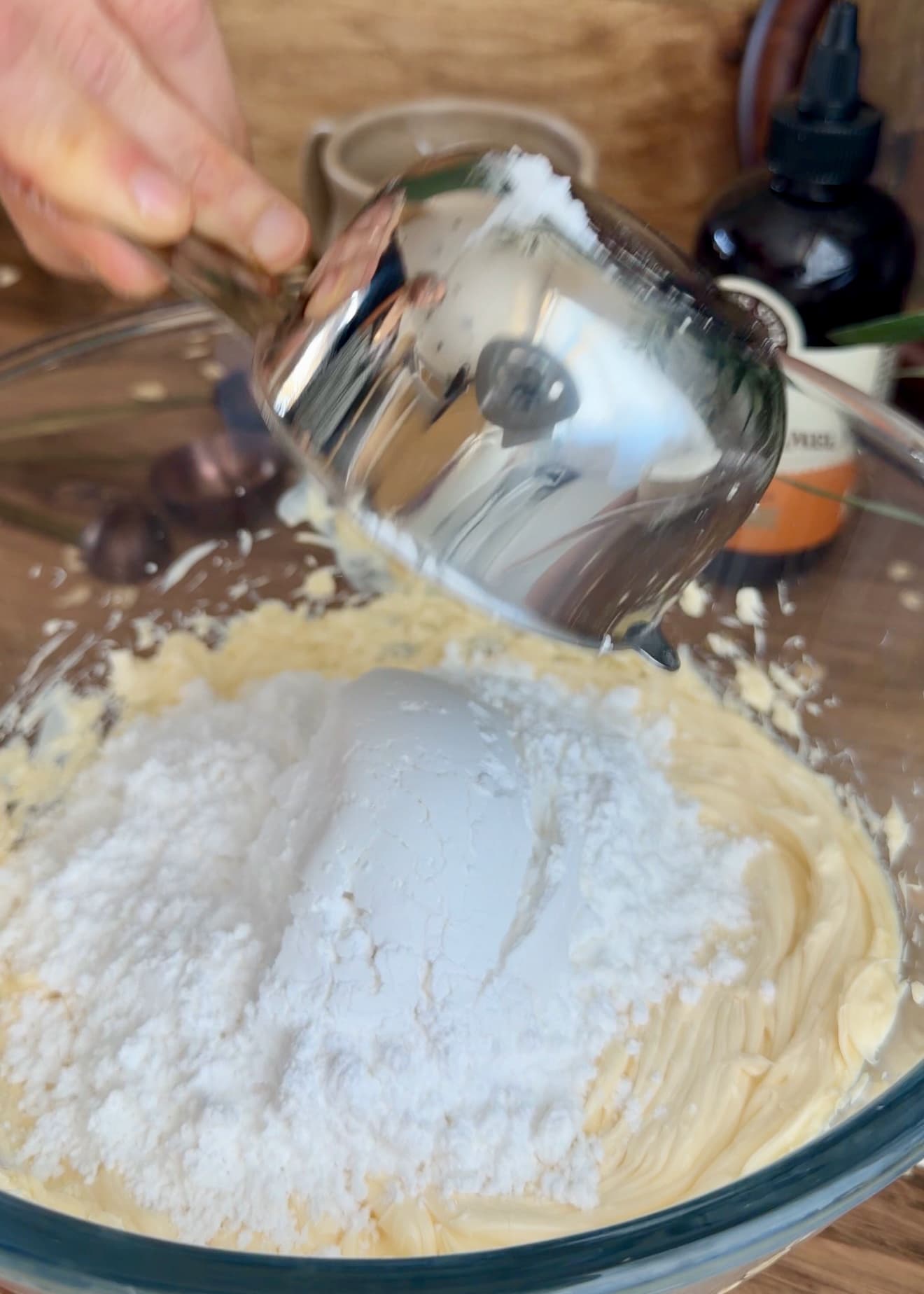 Powdered sugar being poured over the softened filling butter