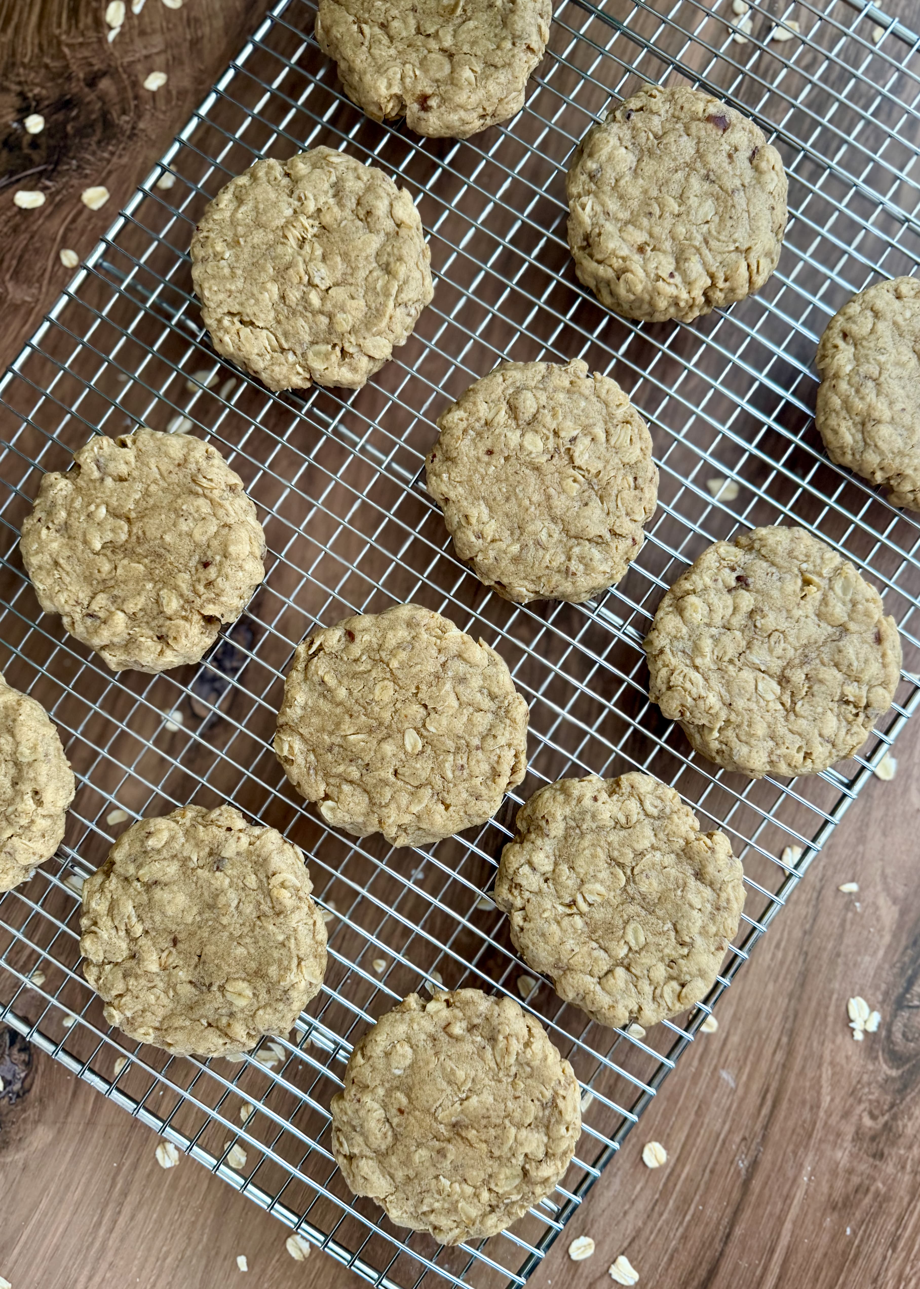Baked oatmeal cookies arranged on a wire cooling rack