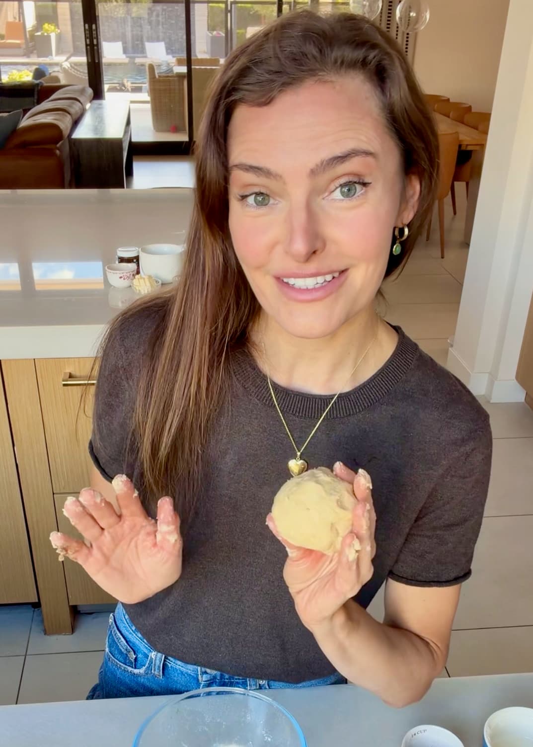 Angela holding the crumble squeezed into a ball