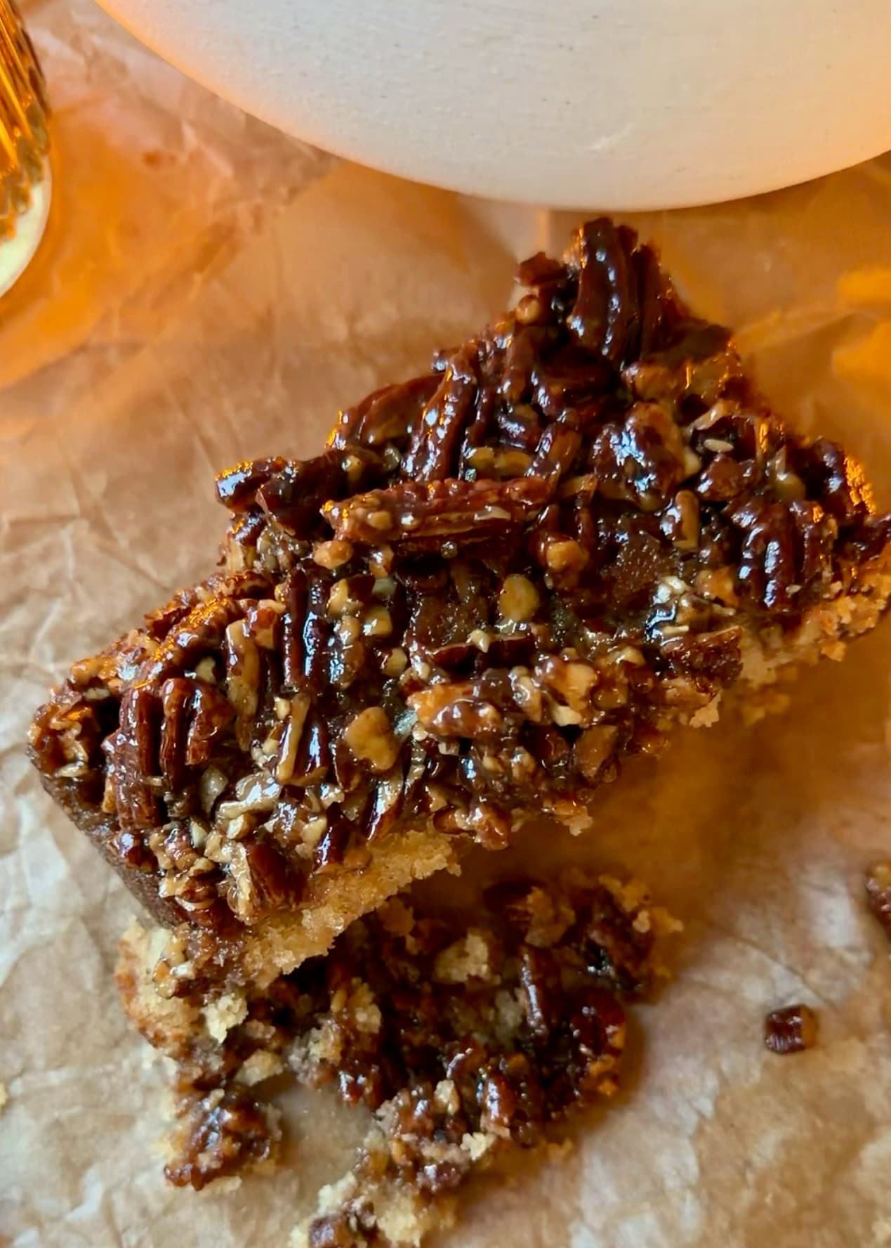 A pecan-topped slice of Sticky Bun Donut Loaf on parchment