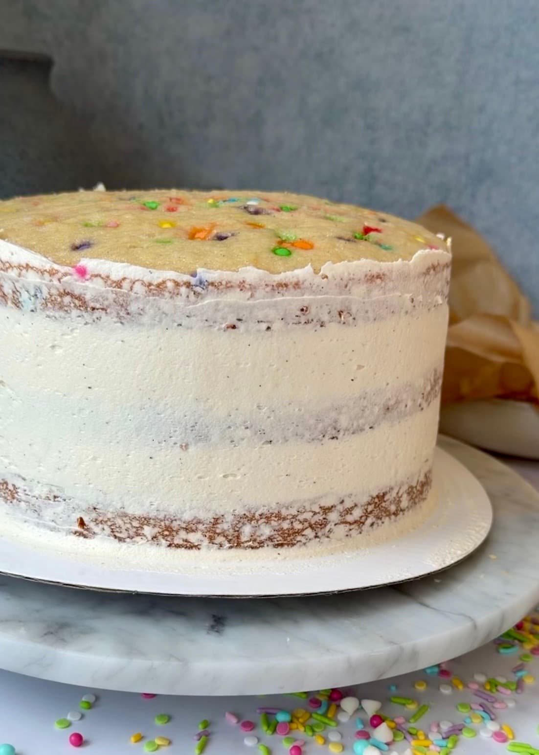 Stacked cake with a thin smoothed buttercream coating on the sides