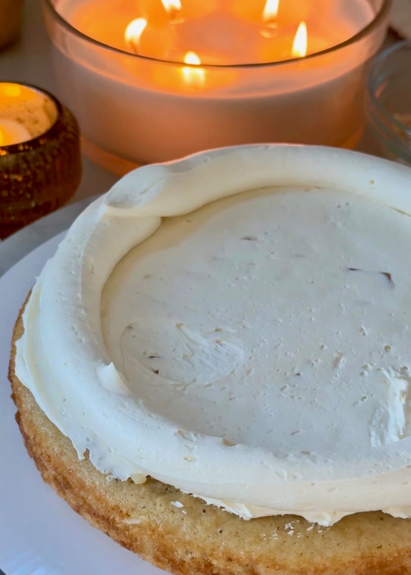 Vanilla buttercream spread over a macadamia cake layer inside a piped buttercream dam