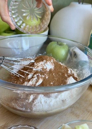 Flour and warm spices added to the apple fritter donut loaf batter
