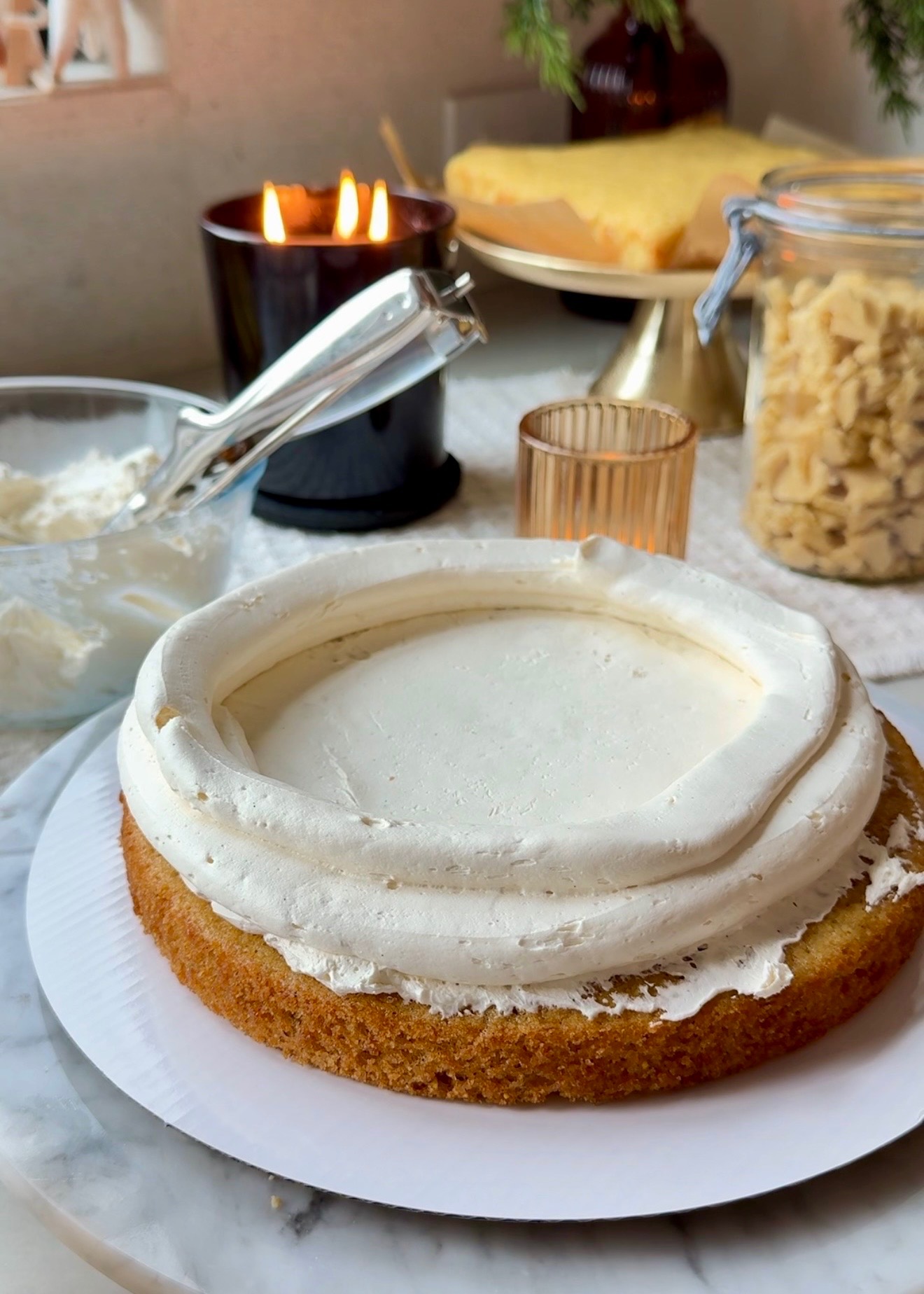 Tall vanilla buttercream dam piped around a cornbread cake layer