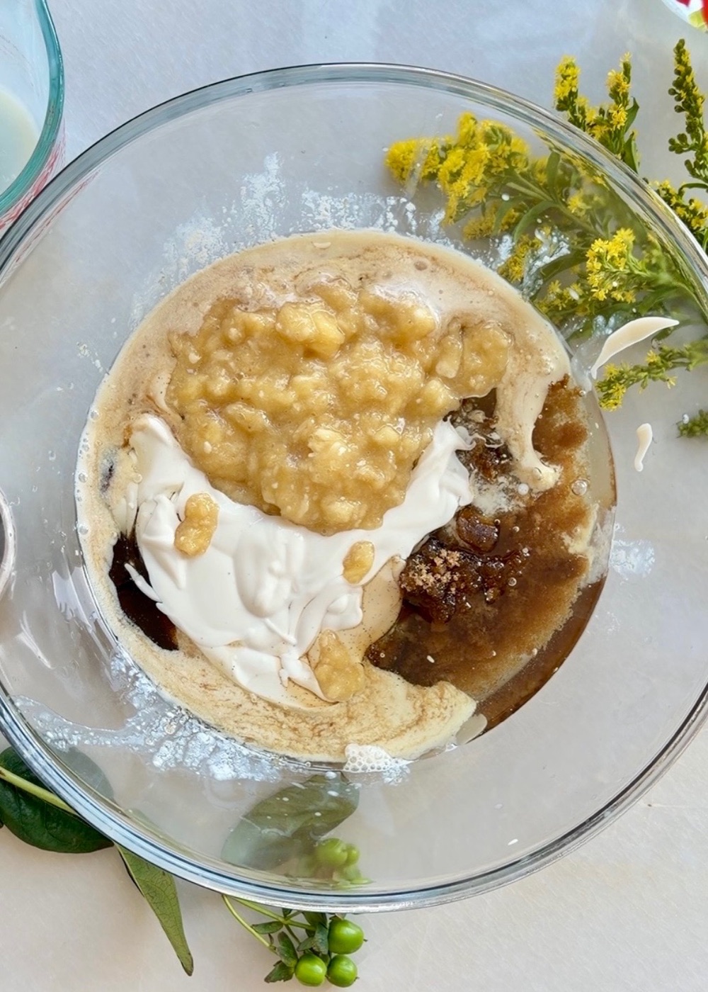 Very ripe mashed bananas with the wet ingredients for banana cake
