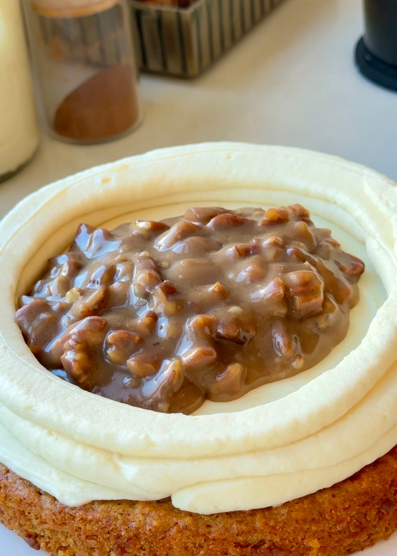 Brown sugar-pecan praline filling inside a cheesecake frosting dam