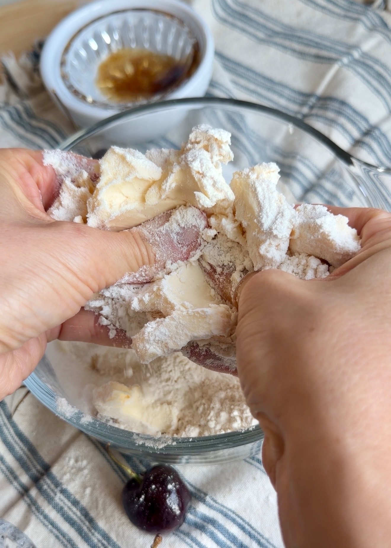 Cold butter being worked into flour and sugar by hand for streusel