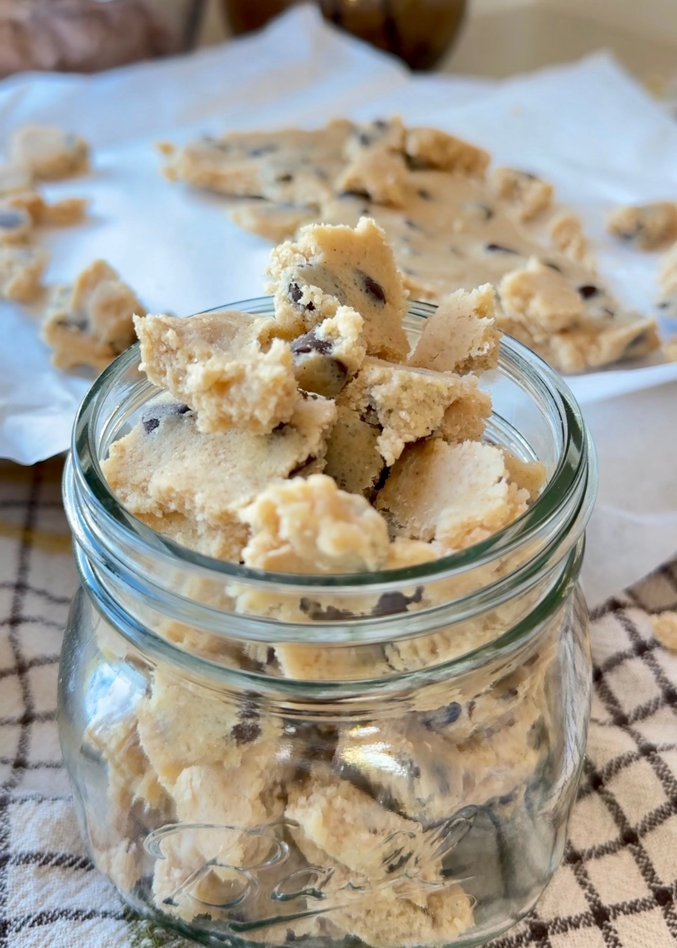 Chocolate chip cookie dough pieces in a glass jar