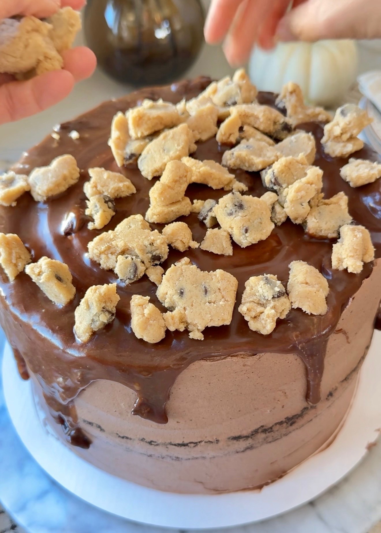 Finished chocolate cookie dough lava cake with glossy drips and cookie dough pieces