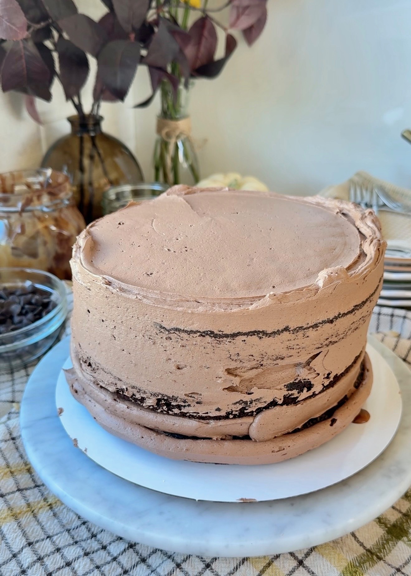 Three-layer chocolate cake coated with chocolate buttercream