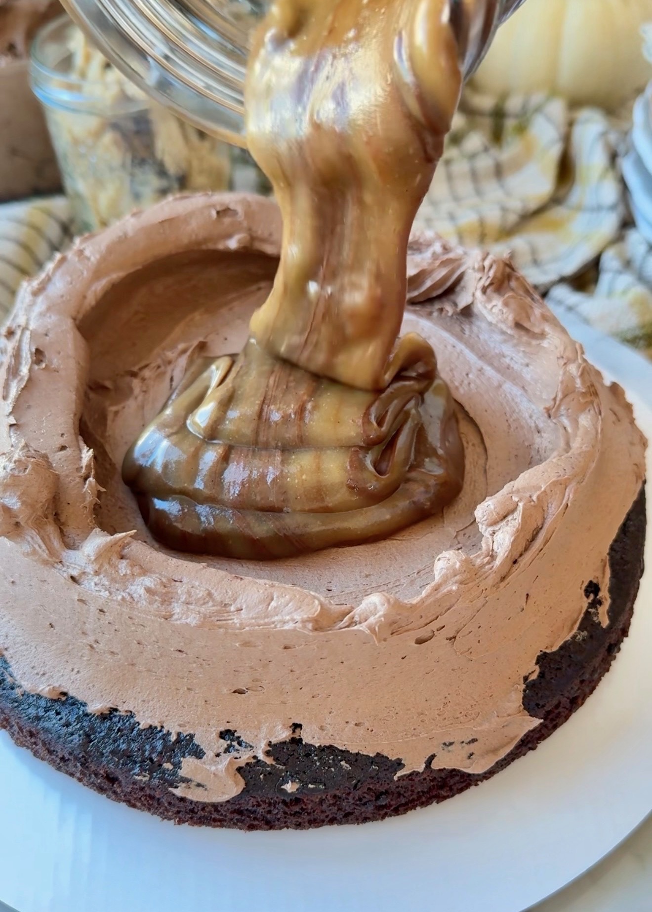 Cookie dough lava being poured inside a chocolate buttercream dam