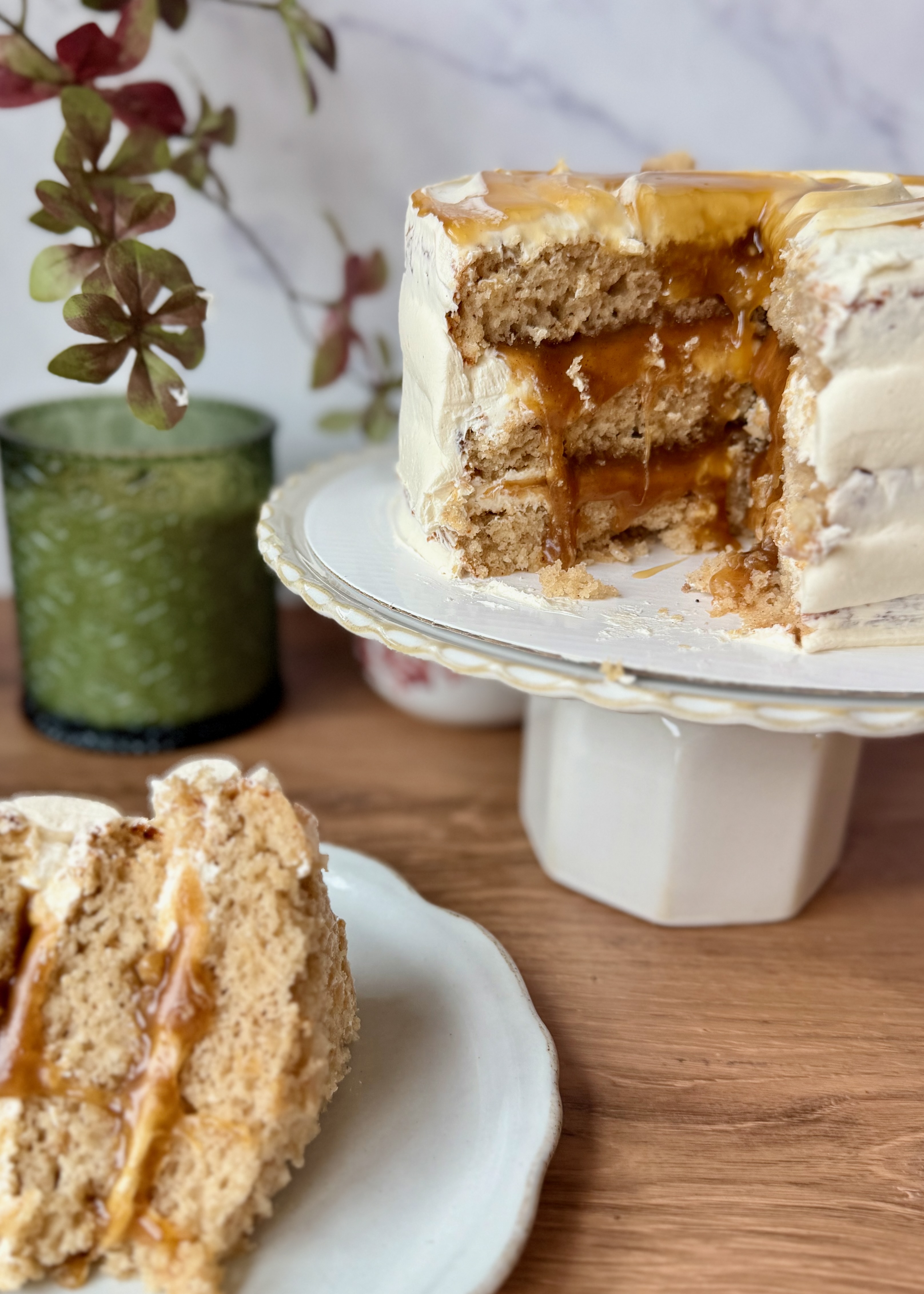 Cinnamon Roll Lava Cake with a slice plated beside the cut layer cake