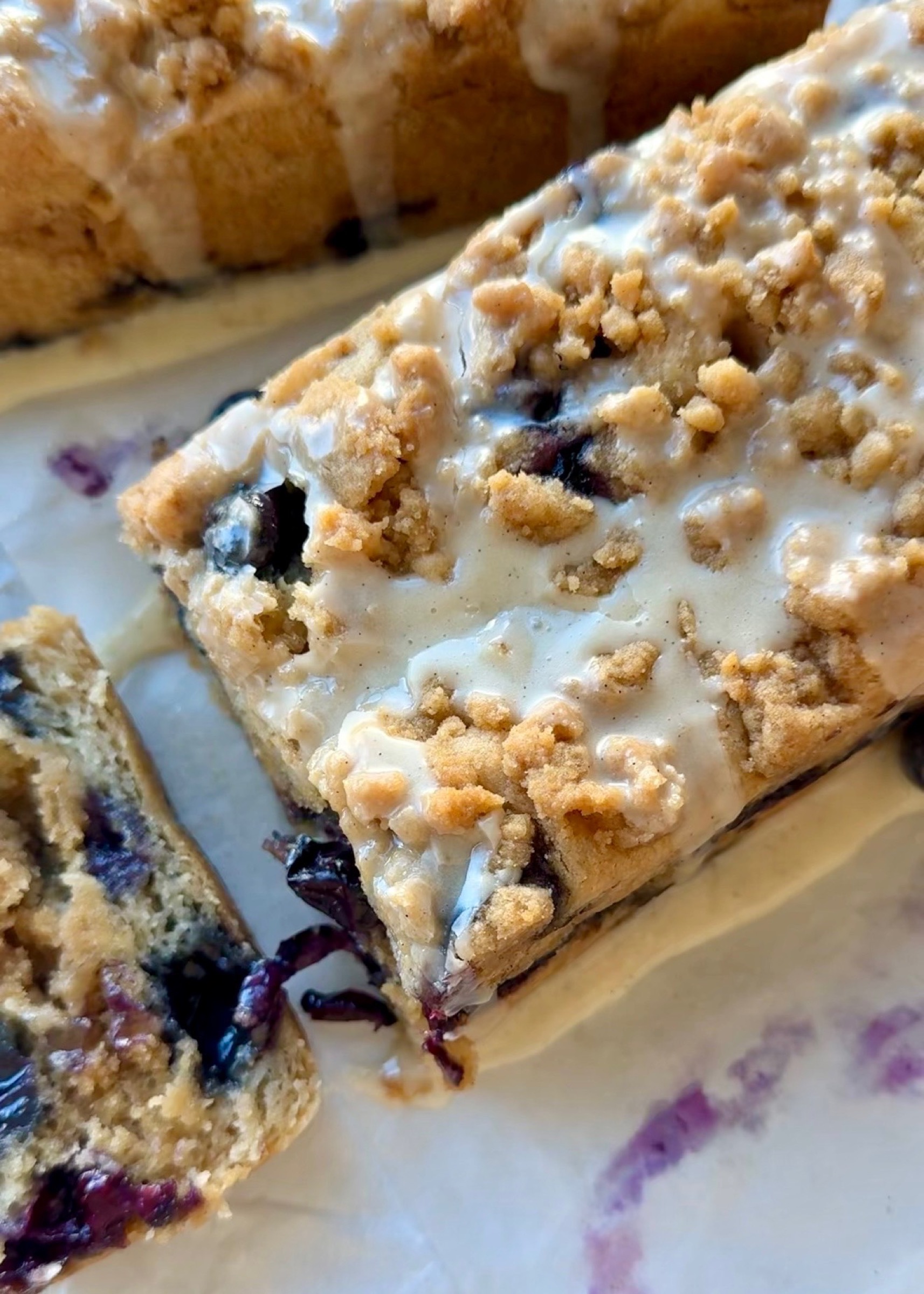 Close overhead view of vanilla glaze and streusel on Gluten-Free Blueberry Coffee Cake