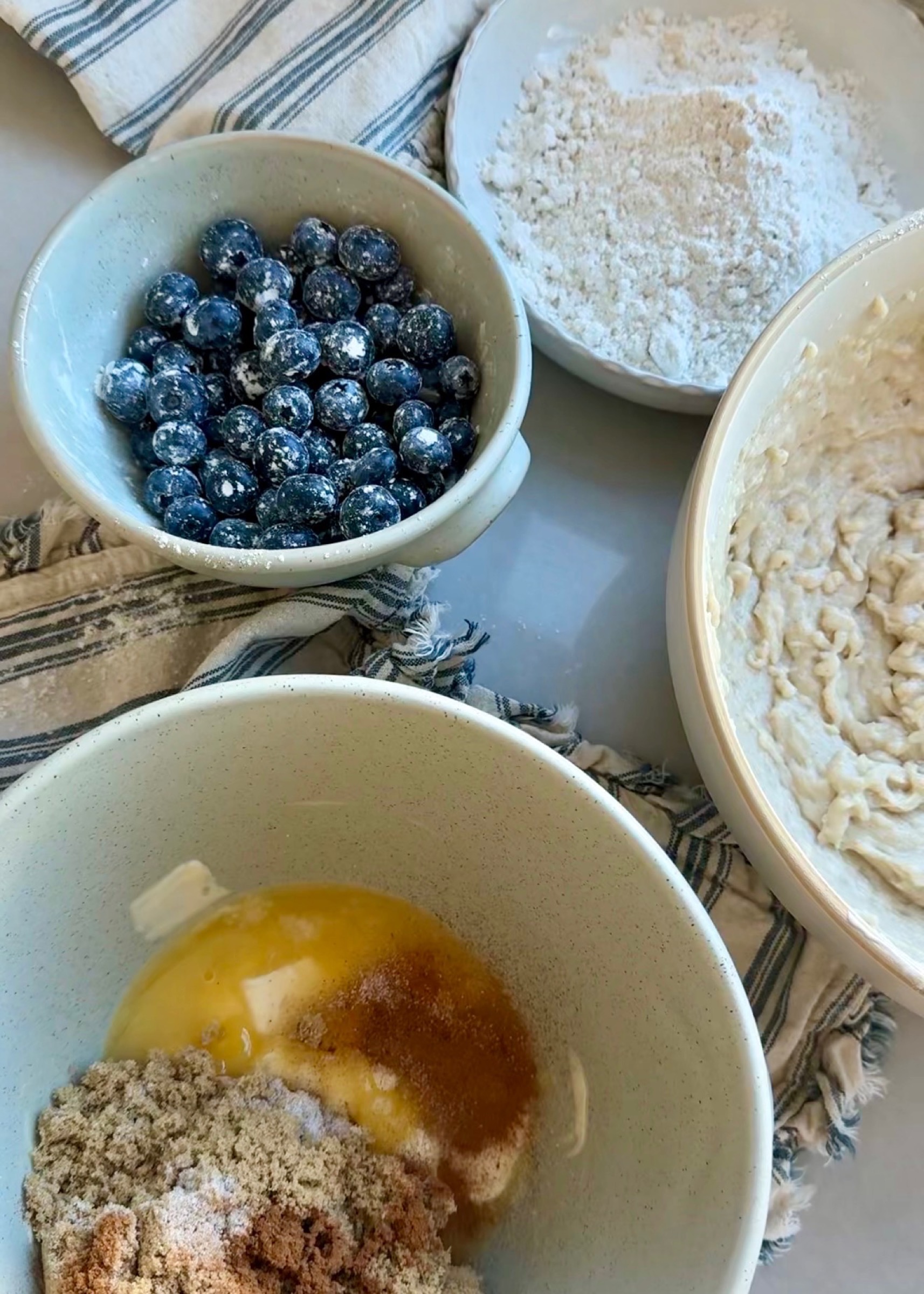 Cold butter, brown sugar, cinnamon, blueberries, and gluten-free coffee cake batter in bowls