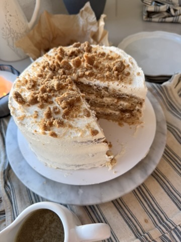 Layered coffee cake with a slice removed to show cinnamon streusel between the layers