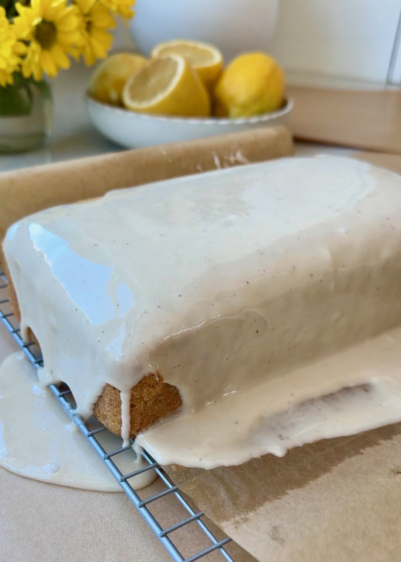Lemon poppy seed donut loaf covered in a thin vanilla glaze