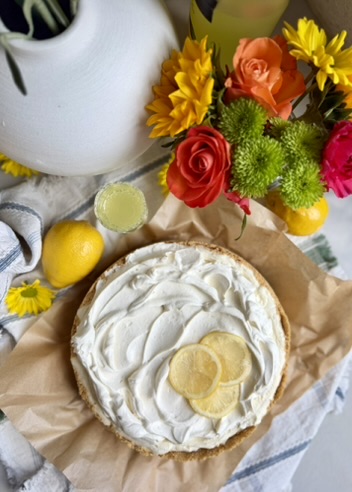 Finished Limoncello Cheesecake Mousse topped with softly swirled whipped cream and lemon slices
