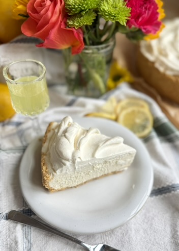 Plated slice of Limoncello Cheesecake Mousse with limoncello and colorful flowers