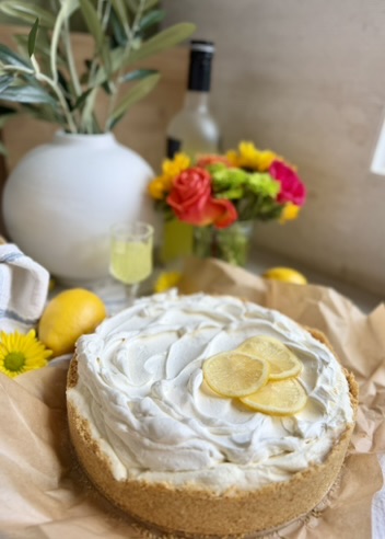 Whole Limoncello Cheesecake Mousse with lemon slices and fresh flowers