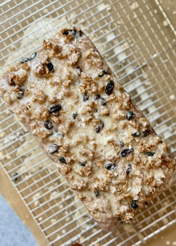 Oatmeal Cookie Donut Loaf covered in vanilla glaze and oatmeal raisin streusel