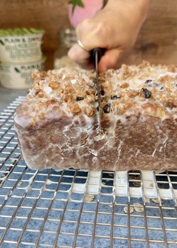 Knife slicing through a glazed Oatmeal Cookie Donut Loaf