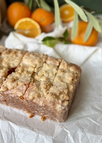 Sliced Orange Old-Fashioned Donut Loaf surrounded by fresh oranges