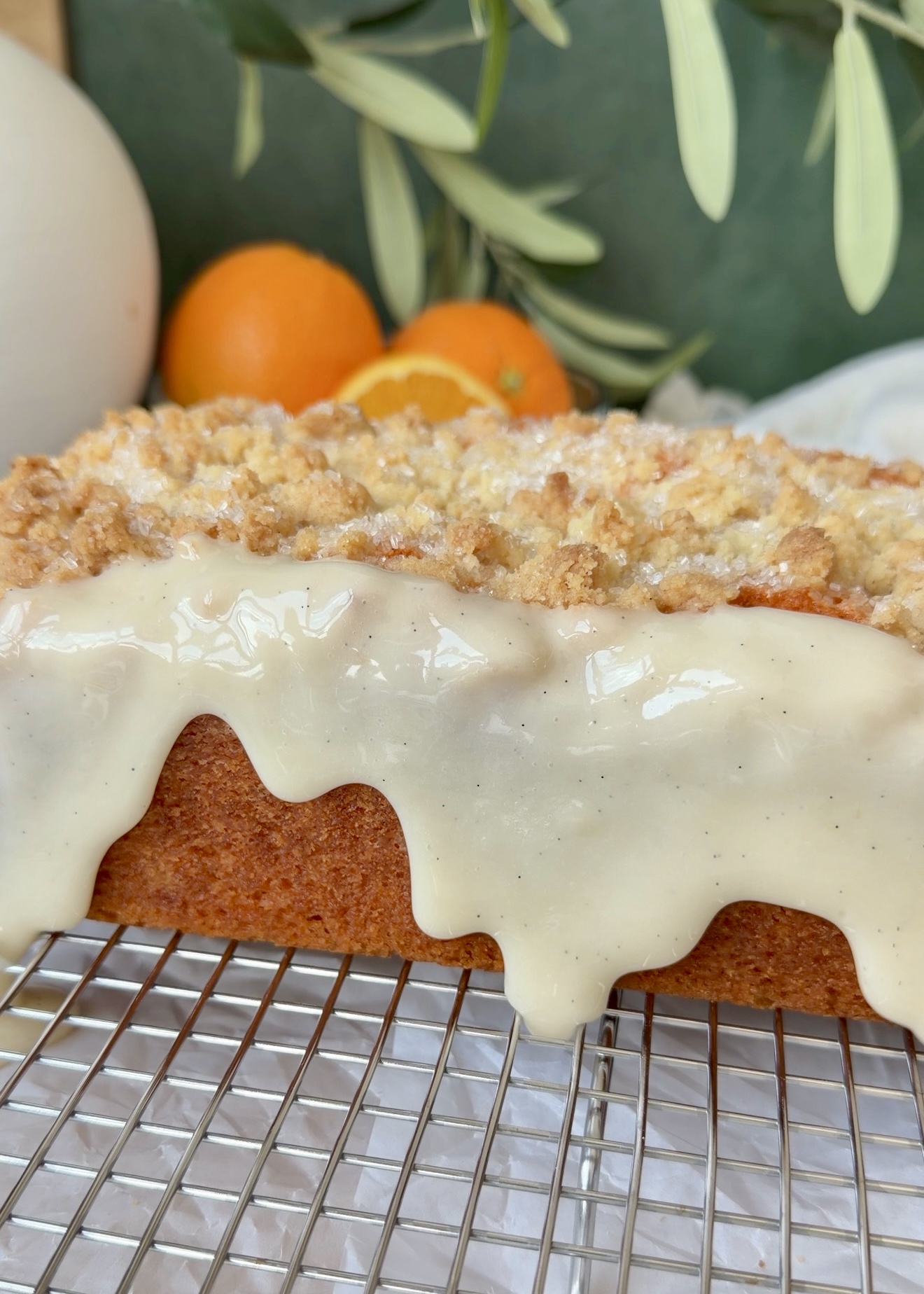 Vanilla bean glaze dripping over the finished orange donut loaf