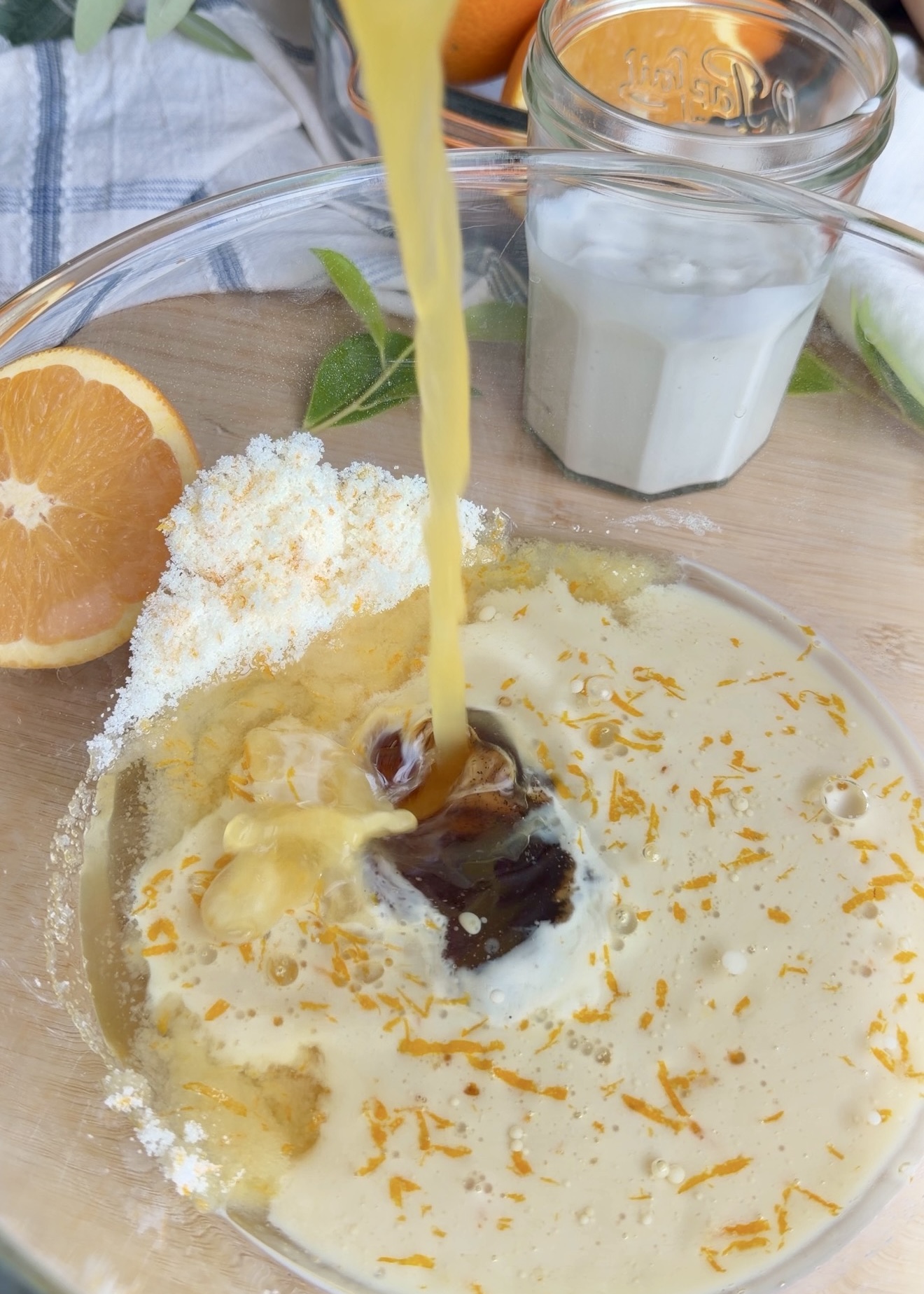 Milk being poured into orange loaf wet ingredients
