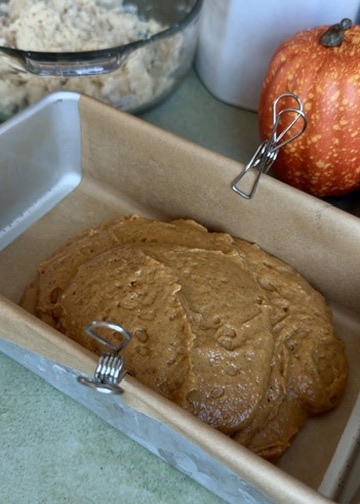 First layer of pumpkin spice batter in a parchment-lined loaf pan