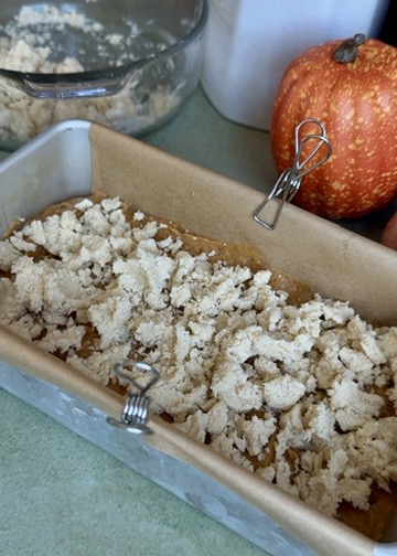 Buttery streusel covering the first layer of pumpkin spice batter