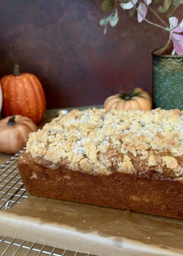 Unglazed pumpkin spice donut loaf cooling on a wire rack