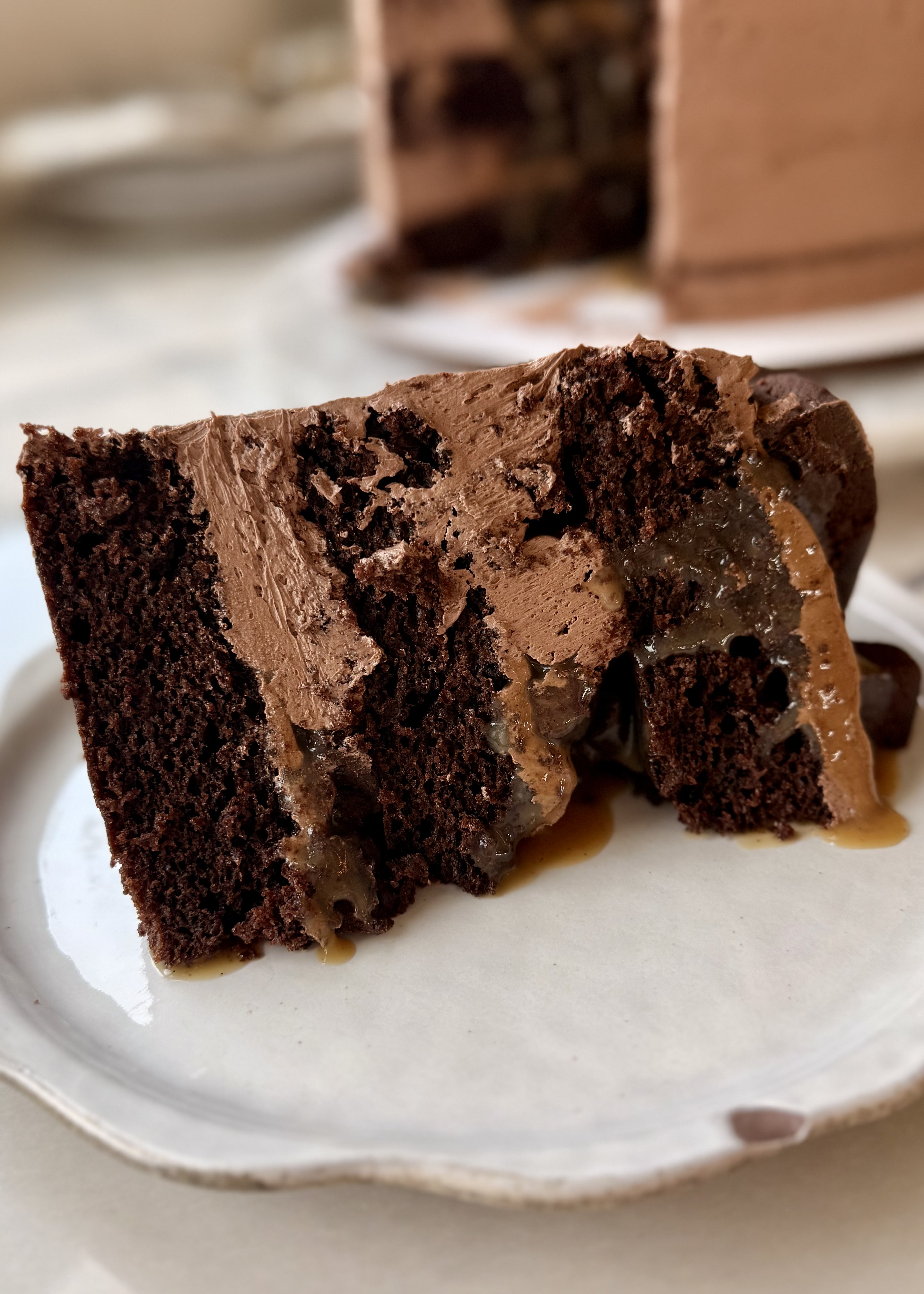 Slice of Salted Caramel Brownie Lava Cake with caramel flowing between the chocolate layers
