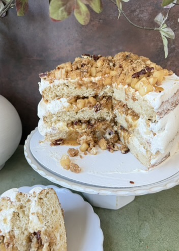 Cut Salted Caramel Dutch Apple Pie Cake showing vanilla layers, apples, streusel, and caramel