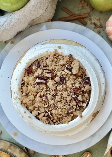 Brown sugar pecan streusel layered over apples inside a buttercream dam