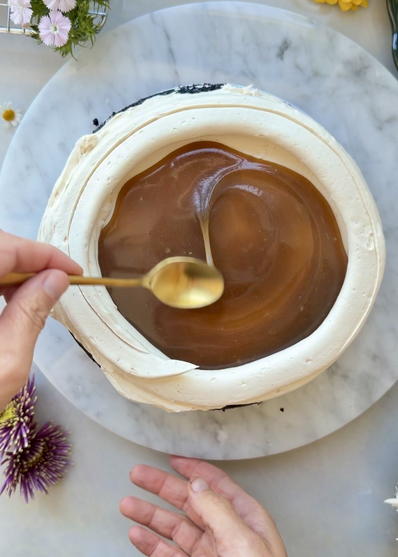 Salted brown sugar caramel spread inside a buttercream dam on mocha cake