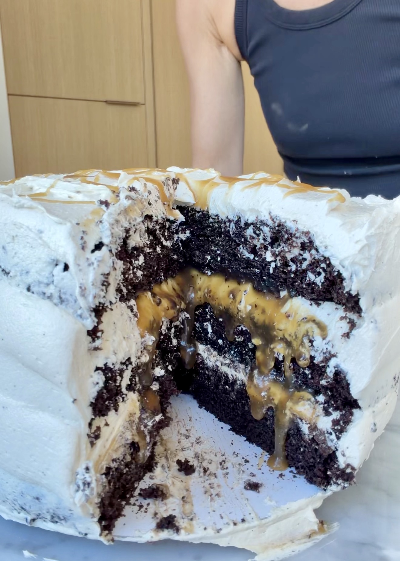 Cut mocha layer cake with salted caramel flowing between the layers