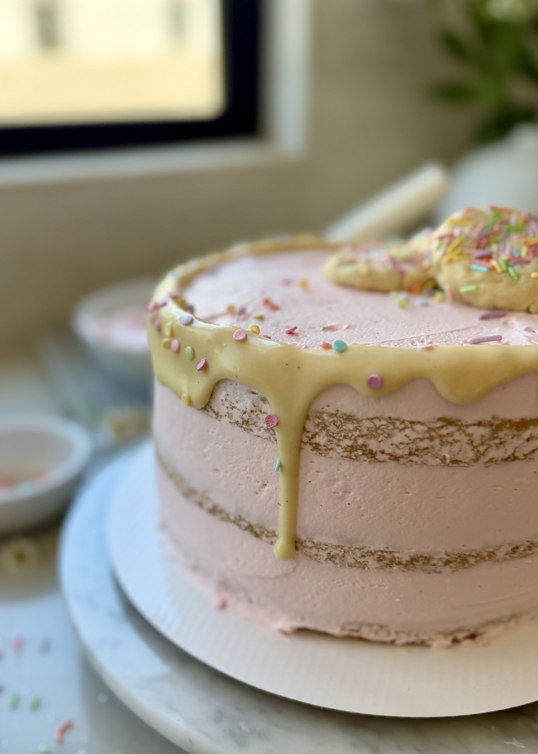 Side view of the completed Sugar Cookie Lava Cake with pink buttercream and vanilla lava drip