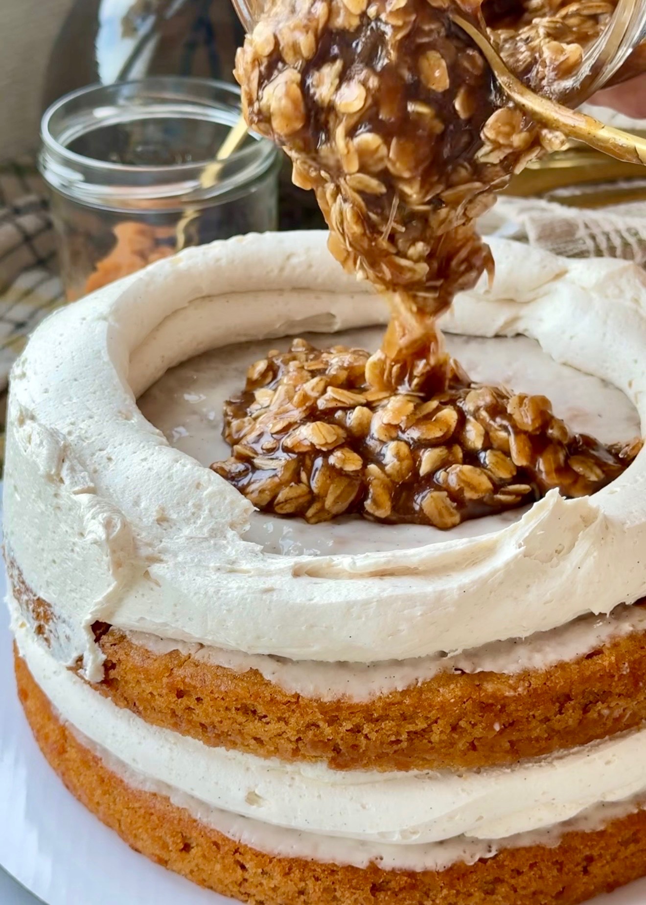 Chewy oatmeal caramel being spooned inside a buttercream dam
