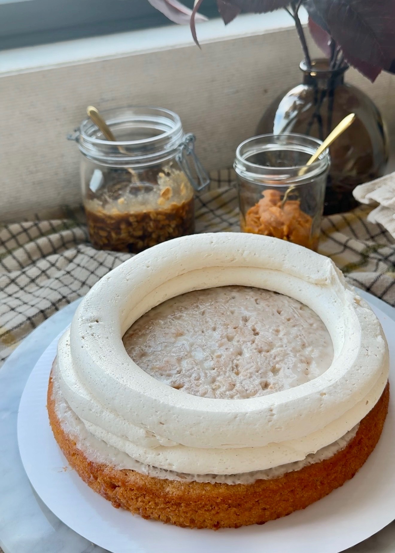 Brown sugar buttercream dam piped around a sweet potato cake layer