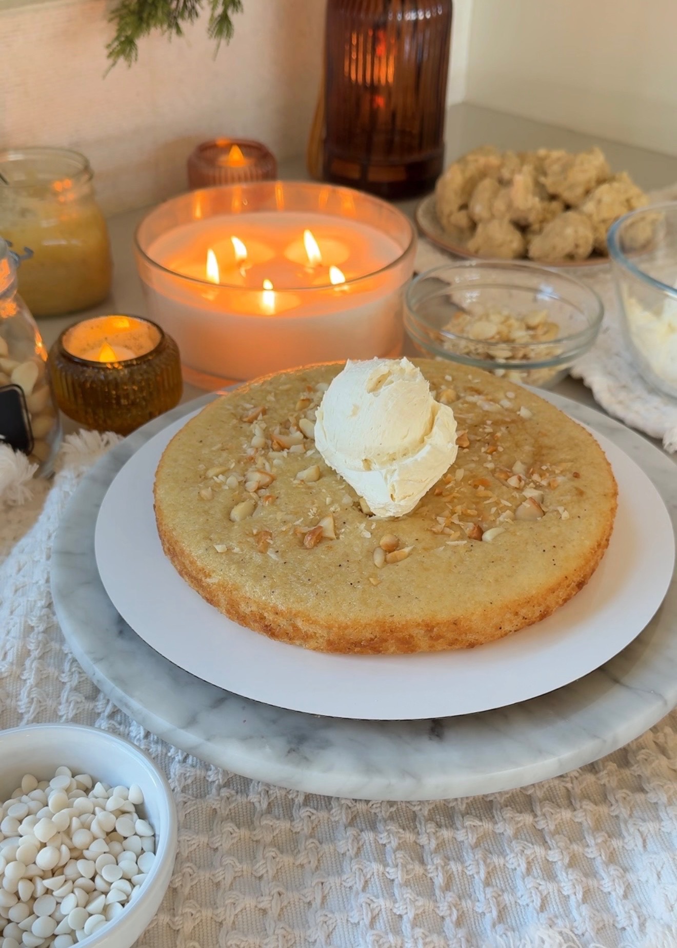 Vanilla macadamia cake layer with chopped nuts and a scoop of vanilla buttercream